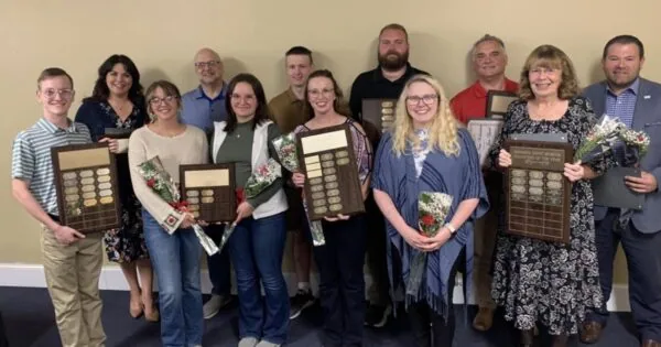 A group of Dennison Railroad Depot Museum volunteers are holding their awards.