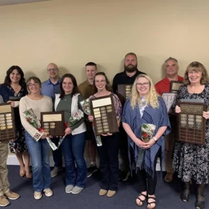 A group of Dennison Railroad Depot Museum volunteers are holding their awards.