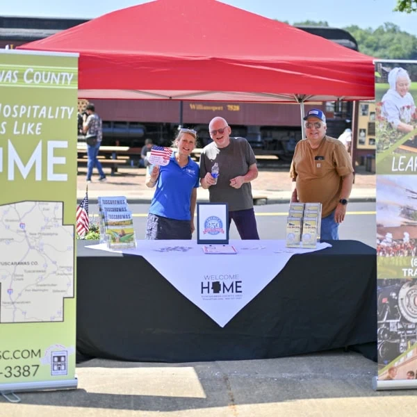 People at an event display booth.